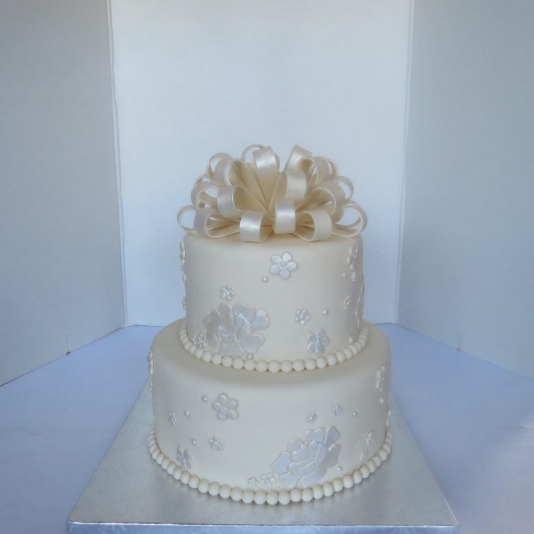 Cream colored cake with loop bow